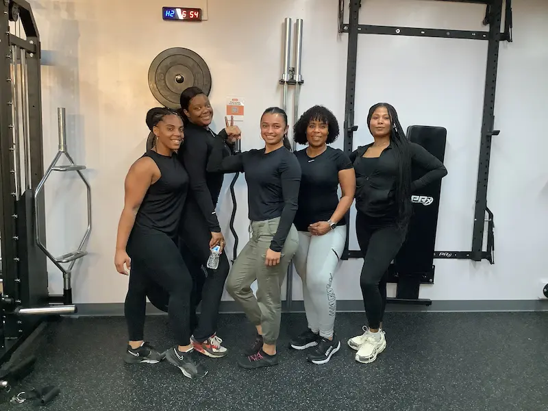 Five PinPoint members posing together in the training studio